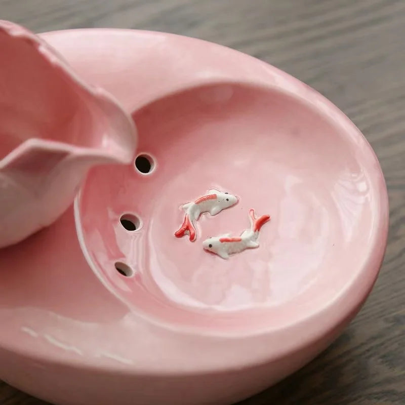 Ceramic pet water fountain with USB pump for cats and other pets to drink water.